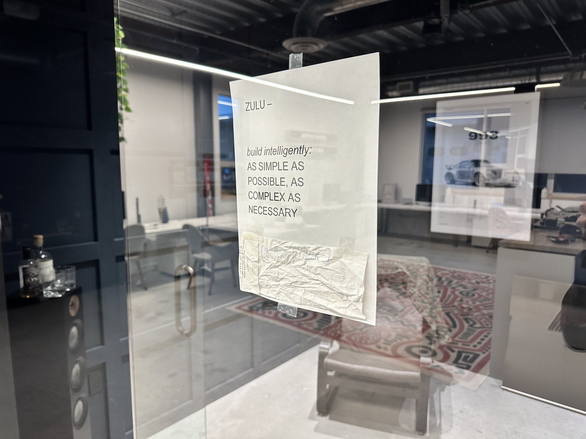 The printed sign on the office glass, with the receipt taped beneath it.